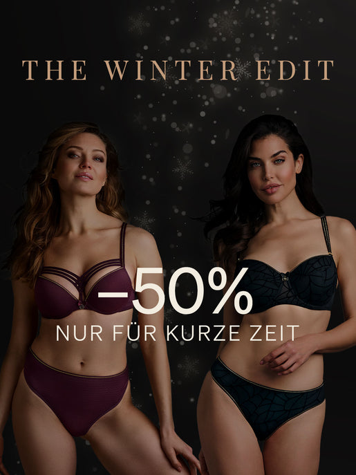 Zwei Models tragen das Auberginen-Flüsterset „Dame de Paris“ und das schwarz-goldene Lurex-Set „The Adventuress“. Dunkler Hintergrund mit Schneeflocken für die Winter-Edit-Aktion von marlies|dekkers mit -50 %