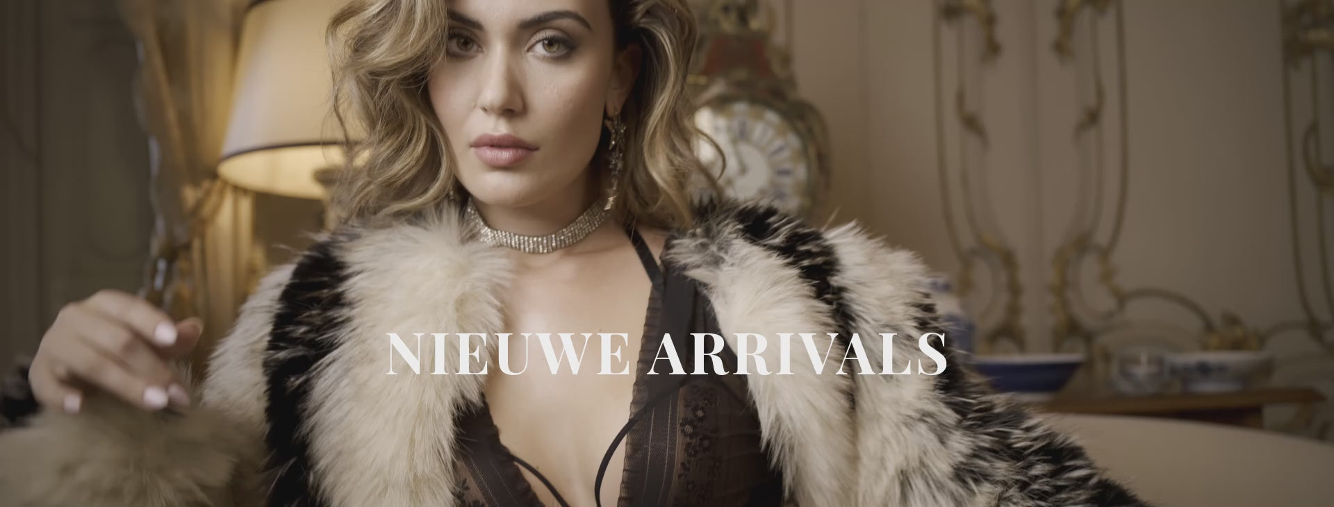 Video of a model with shoulder-length brunette hair wearing a black floral lace lingerie set from marlies|dekkers. She turns to show the bra and matching briefs from the front, side, and back, highlighting the fit and intricate lace details. The word 'nieuwe arrivals' appears as an on-screen text overlay.